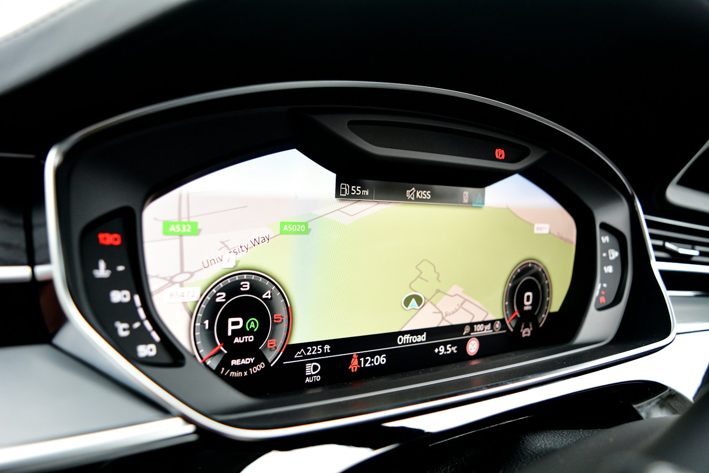 Modern car dashboard with navigation map and speed display.