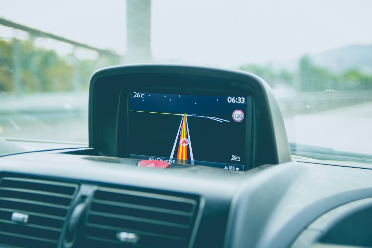 Car GPS screen showing highway route and dashboard.