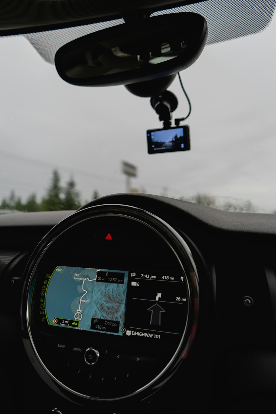 Car dashboard with navigation map on infotainment screen.